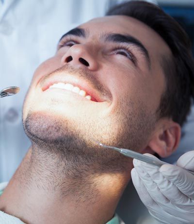 patient getting his teeth cleaned at Florham Park Smile Lounge